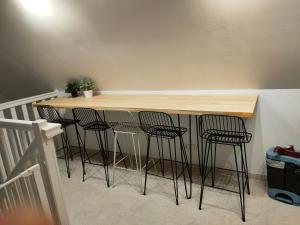 a kitchen with a bar with stools around it at Chez YEP, 4 chambres 9 couchages in Anzin-Saint-Aubin +8 photos