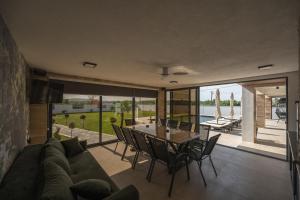 a living room with a couch and a table and chairs at Vila Lux in Tešanovića Mala