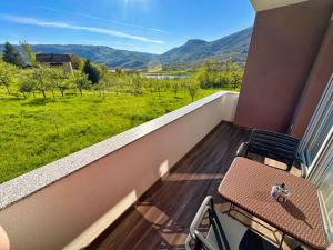 a balcony with a table and two chairs and a view at Apartmani Jozić 2 in Ripci