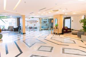an office lobby with a large tile floor at Zawaya Almasia Hotel 2 in Medina