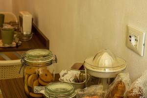 a kitchen counter with a jar of donuts and a mixer at Ai tre camini in Adro +2 photos