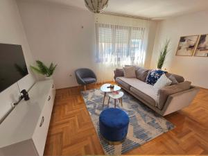 a living room with a couch and a table at Area 51 in Banja Luka