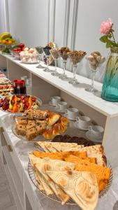 a buffet with many different types of bread and other foods at Velora Hostel in Khiva
