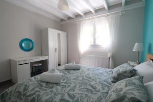 a bedroom with a large bed and a window at Corfu Green Escape in Achílleion