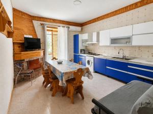 a kitchen with a table and blue cabinets at Casa Vacanze RosMary in Agropoli