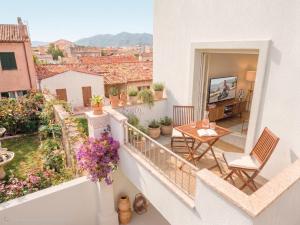 a balcony of a house with a table and chairs at Madau's House Exclusive Apartments in Olbia