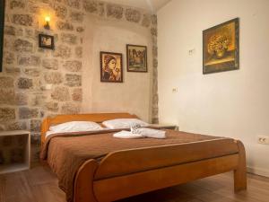 a bedroom with a bed with two towels on it at Old Town Youth Hostel in Kotor +13 photos