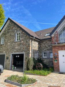 a brick house with a garage at Gladgîte in Waimes