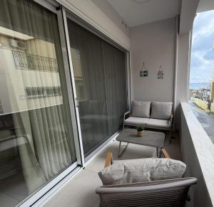 an apartment balcony with a couch and a table at Notos Blue in Tsoutsouros