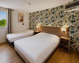 a hotel room with two beds and a window at Hôtel Restaurant Le Relais - Pau Nord in Lons +25 photos