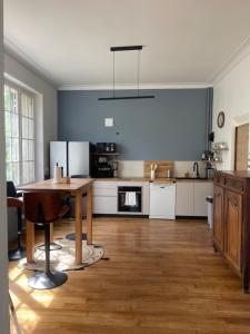 a large kitchen with a wooden table and a dining room at Villa Mayeux in Giverny