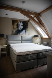 a bedroom with a large bed in a attic at Room4 in Maurik