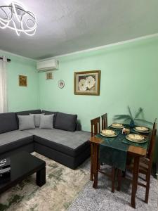 a living room with a couch and a table at Sweet Escape in Shkodër