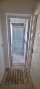 an empty hallway with a door in a room at Maison à louer in Chebba
