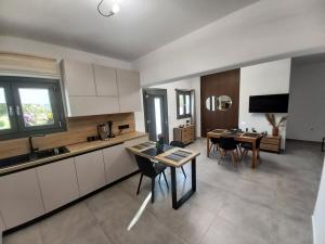 a kitchen and dining room with a table and chairs at Velania House 2 in Filótion