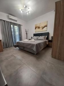 a bedroom with a bed and a ceiling fan at Velania House 2 in Filótion