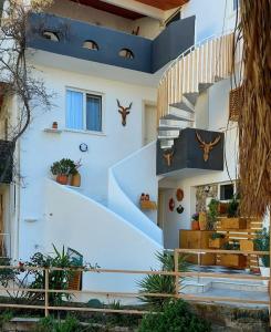 a white house with a spiral staircase at Bohem Pansiyon in Kuşadası