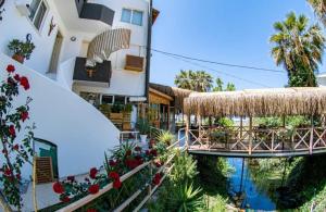 a resort with a bridge and a swimming pool at Bohem Pansiyon in Kuşadası