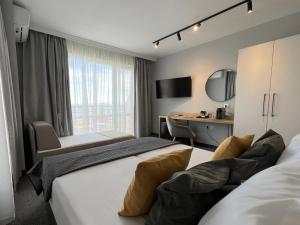 a hotel room with two beds and a desk at HOTEL BRIZ - Free Parking in Burgas +59 photos