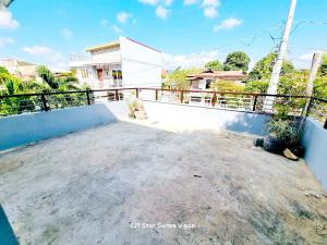 a balcony of a house with a fence at CM Star Suites - Guesthouse in Vigan