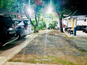 two cars parked at a gas station at night at CM Star Suites - Guesthouse in Vigan