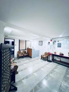 a large room with couches and a fireplace in it at CM Star Suites - Guesthouse in Vigan