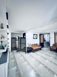 a large room with a stone floor with a couch and a table at CM Star Suites - Guesthouse in Vigan +1 photo