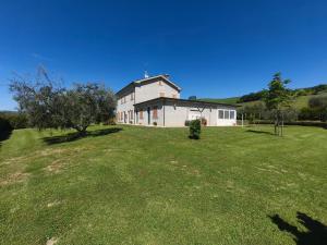 a large white house on a grassy field at B&B La Tenuta del Conte in Fermo +19 photos