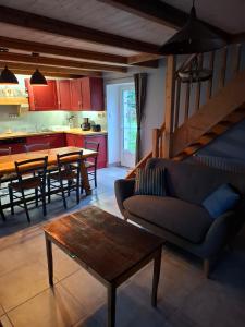 a living room with a couch and a table at Kazh bihan in Guissény