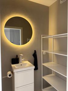 a bathroom with a sink and a mirror at NEU Apartment Lotta in Senftenberg +23 photos