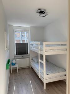 a bedroom with two bunk beds and a window at NEU Apartment Lotta in Senftenberg