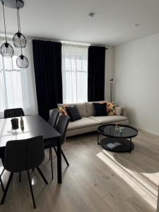 a living room with a couch and a table at NEU Apartment Lotta in Senftenberg