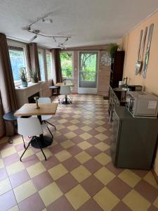 a room with a checkered floor with tables and chairs at B&B Itterhoeve in Neeritter +18 photos