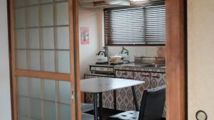 a small kitchen with a table and a stove at KEI HOUSE Yamato 201 in Yamato +38 photos