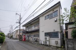 a building on the side of a street at KEI HOUSE Yamato 201 in Yamato