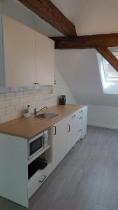 a kitchen with white cabinets and a sink at Dvorek110 in Roudnice nad Labem +37 photos