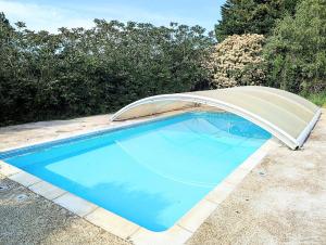 a swimming pool with a cover on top of it at Cottage de charme en pleine nature avec piscine in Saint-Philbert-du-Peuple +7 photos