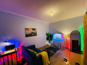 a living room with a couch and a tv at The calm Stay in Nkoanrua
