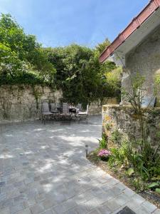 a patio with chairs and a table in a yard at Villa Mayeux in Giverny