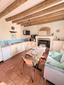 a living room with a table and a couch at Cottage de charme en pleine nature avec piscine in Saint-Philbert-du-Peuple