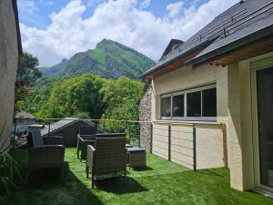 a balcony with chairs and a view of a mountain at Chambre d hotes Spa montagne in Laruns