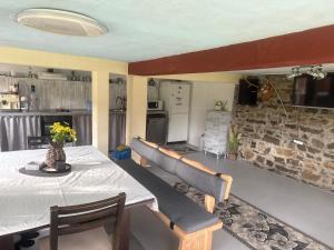 a dining room with a table and chairs and a kitchen at Вила Карапча in Stoyan Zaimovo