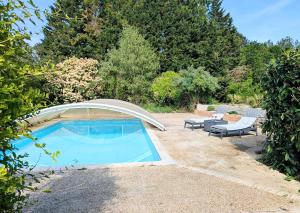 a swimming pool with a cover around it at Cottage de charme en pleine nature avec piscine in Saint-Philbert-du-Peuple