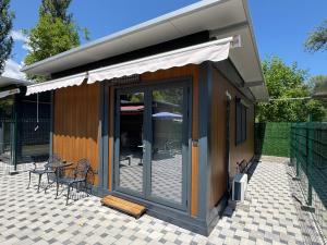 a small house with a patio with a table and chairs at Sand and stone oasis in Ohrid