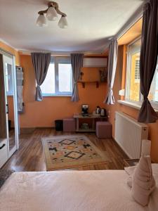 a bedroom with a bed and a living room at Casa Maya with private parking in Oradea