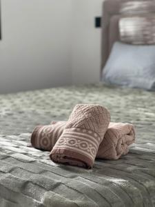 a towel animal is laying on a bed at Appart laouina in El Aouina Station
