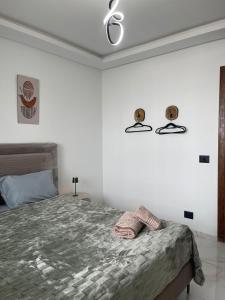 a bedroom with a bed and two skulls on the wall at Appart laouina in El Aouina Station