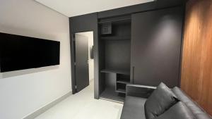 a living room with a couch and a flat screen tv at Porto2life Máximo 6 pessoas in Porto De Galinhas