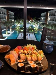 a plate of sushi with a view of a resort at Porto2life Máximo 6 pessoas in Porto De Galinhas