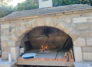 a large brick oven with a fire in it at Apartmani Roko in Ražanac